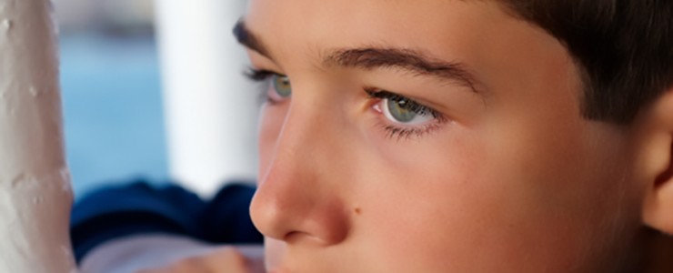 boy looking through window