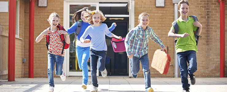 school children running out of the building, happy to leave