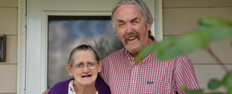 Mike and his wife outside their home