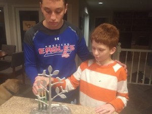 two brothers lighting the menorah