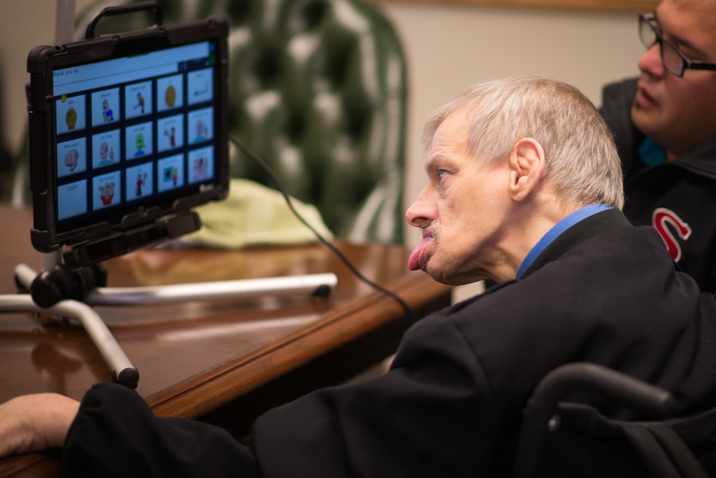 man in wheelchair uses screen based picture software