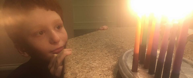 young boy with menorah