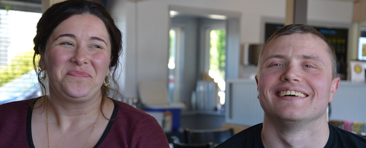 Krista and Michael, smiling, inside coffee shop