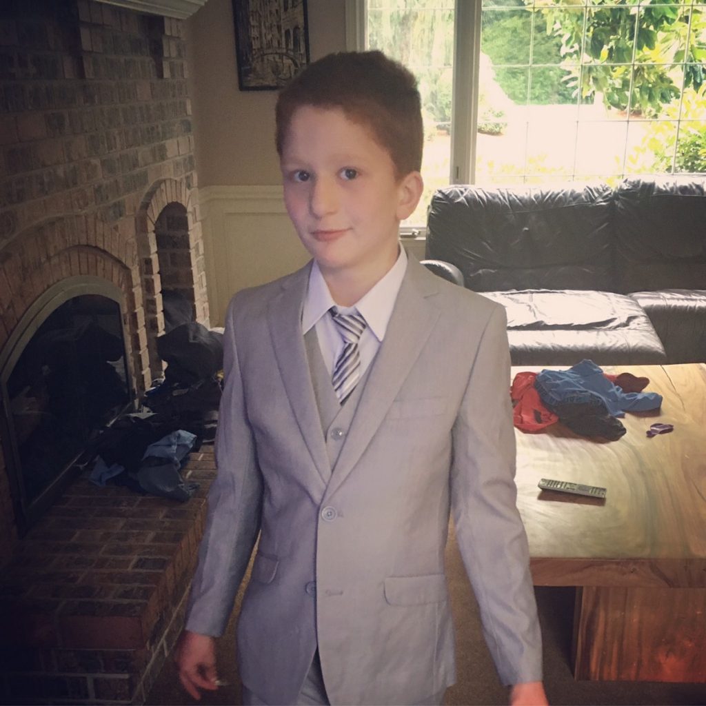 Nate wearing a three piece gray suit