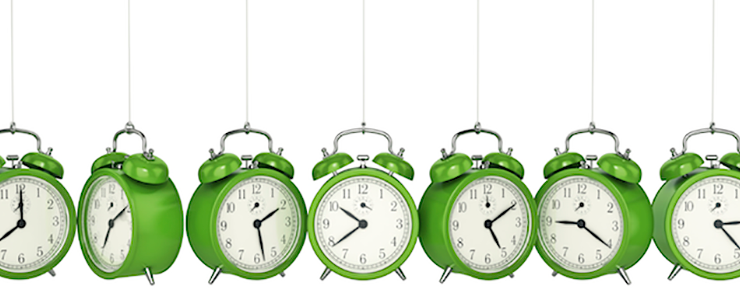 row of alarm green alarm clocks hanging from chains