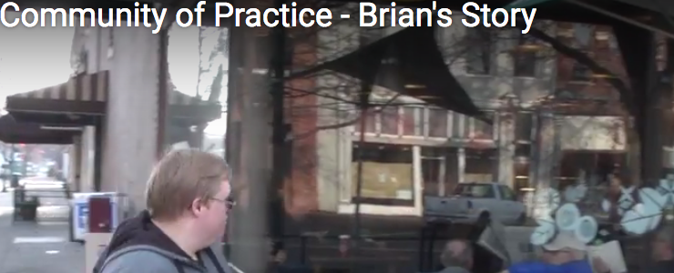 Screen shot from video, showing Brian walking outside a coffee shop. Video title reads: Community of Practice Brian's Story