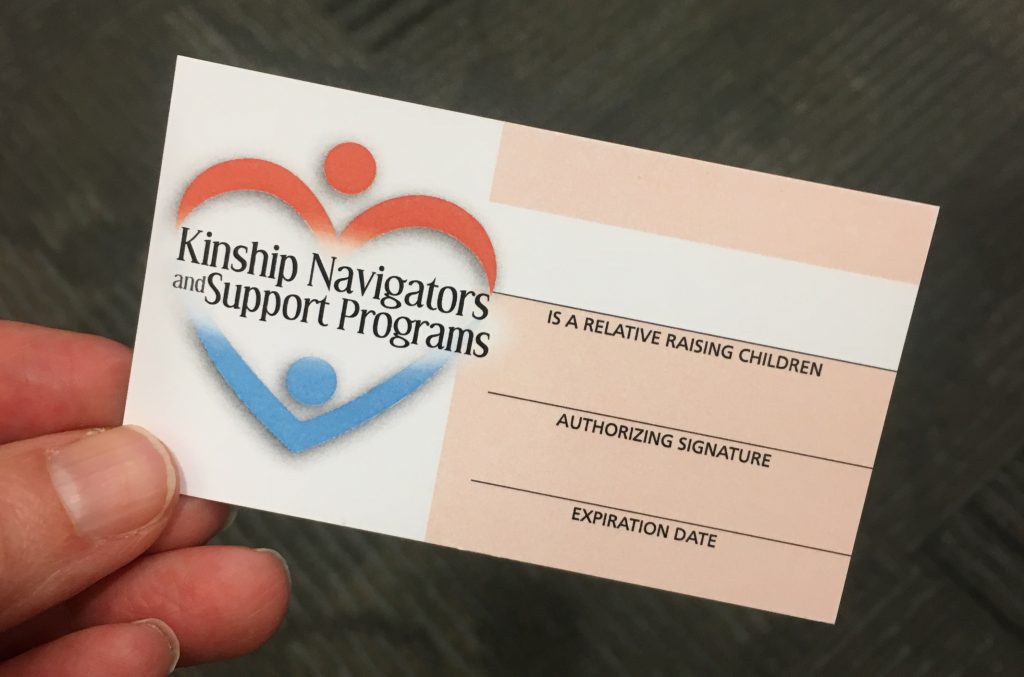 hand holding a blank Kinship Navigators and Support Programs card.