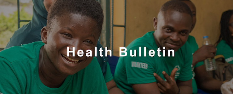 Persons of color smiling, indoors, wearing green Special Olympics t-shirts. Text in white lettering reads Health Bulletin.