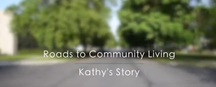 Blurred background of treelined street. Text: Roads to Community Living Kathy's Story.