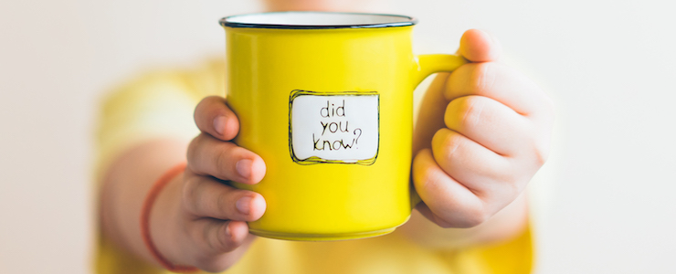 A girl in a yellow T-shirt with a yellow cup in her hand, on which was written Did you know. Interesting fact.