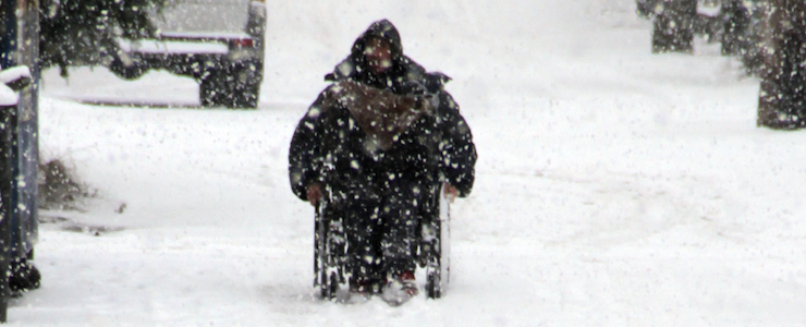 A man in a wheelchair during a Vancouver Snowstorm
