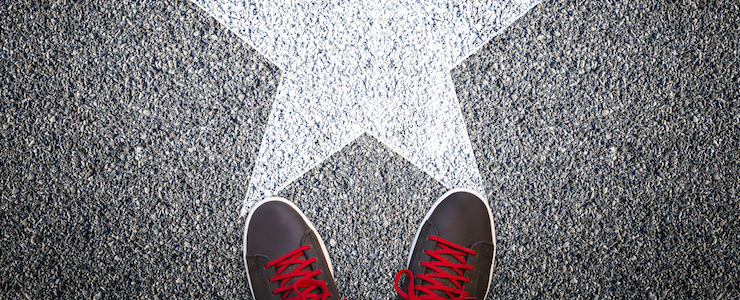 Sneakers on asphalt road with white star