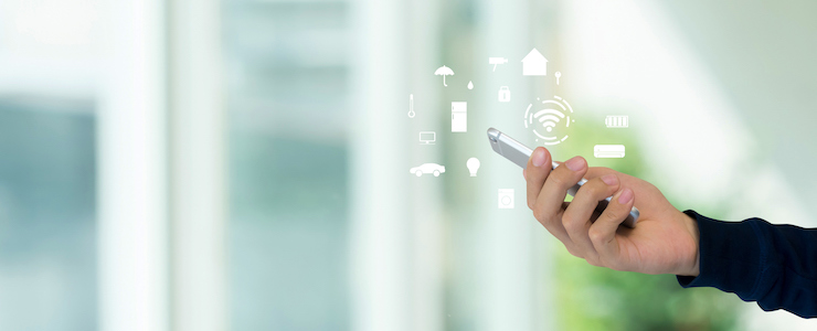close up man holding smartphone and turn on wifi technology for using home automation function to looking inside or outside home and property.