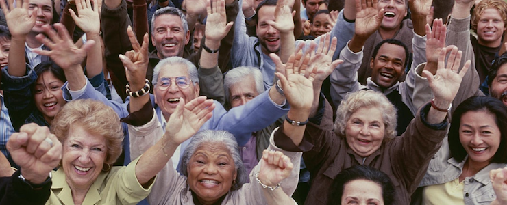 Older adults in a crowd, cheering.