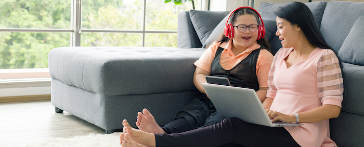 Mother and daughter at home on computer.
